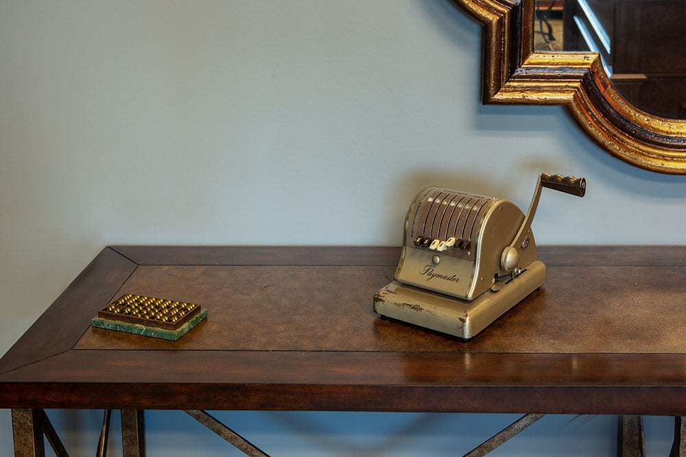 Abacus and vintage Paymaster check writing machine on a table